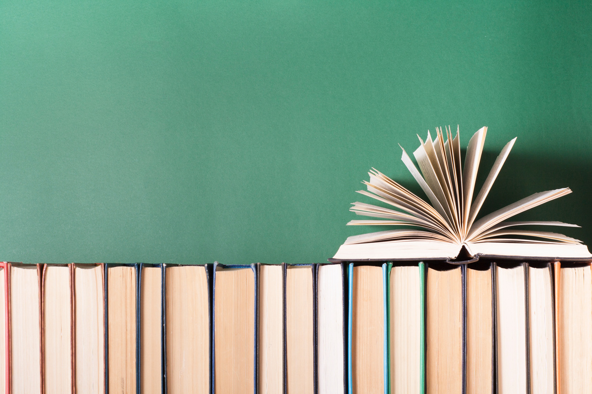 Open book, hardback books on wooden table. Education background. Back